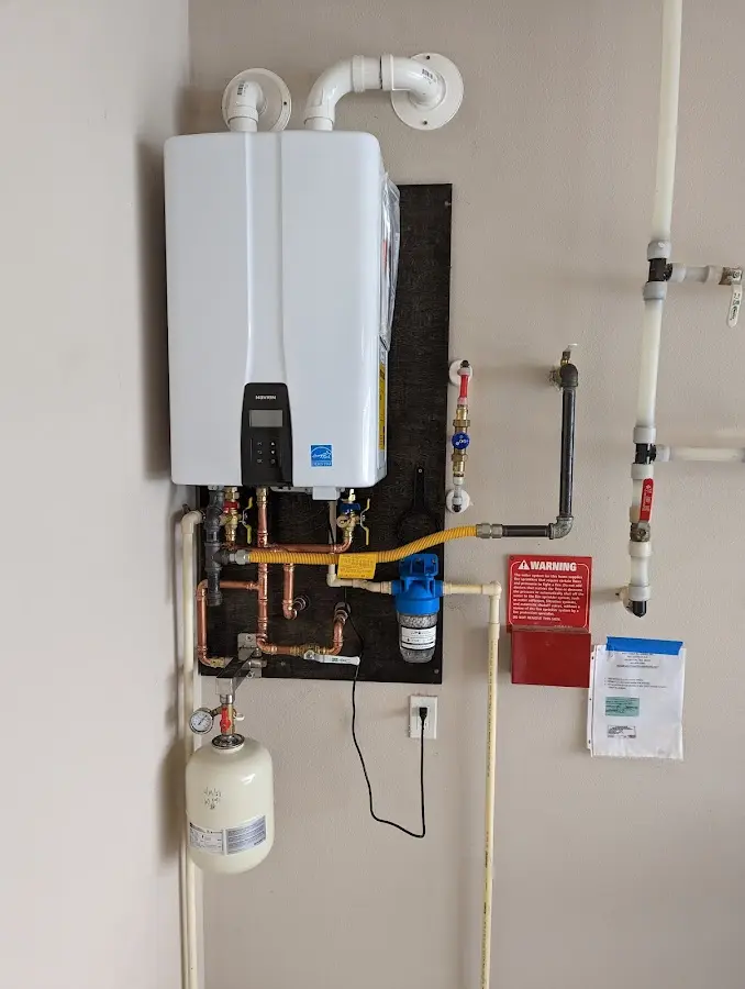 Professional plumber installing copper piping in a Linden home